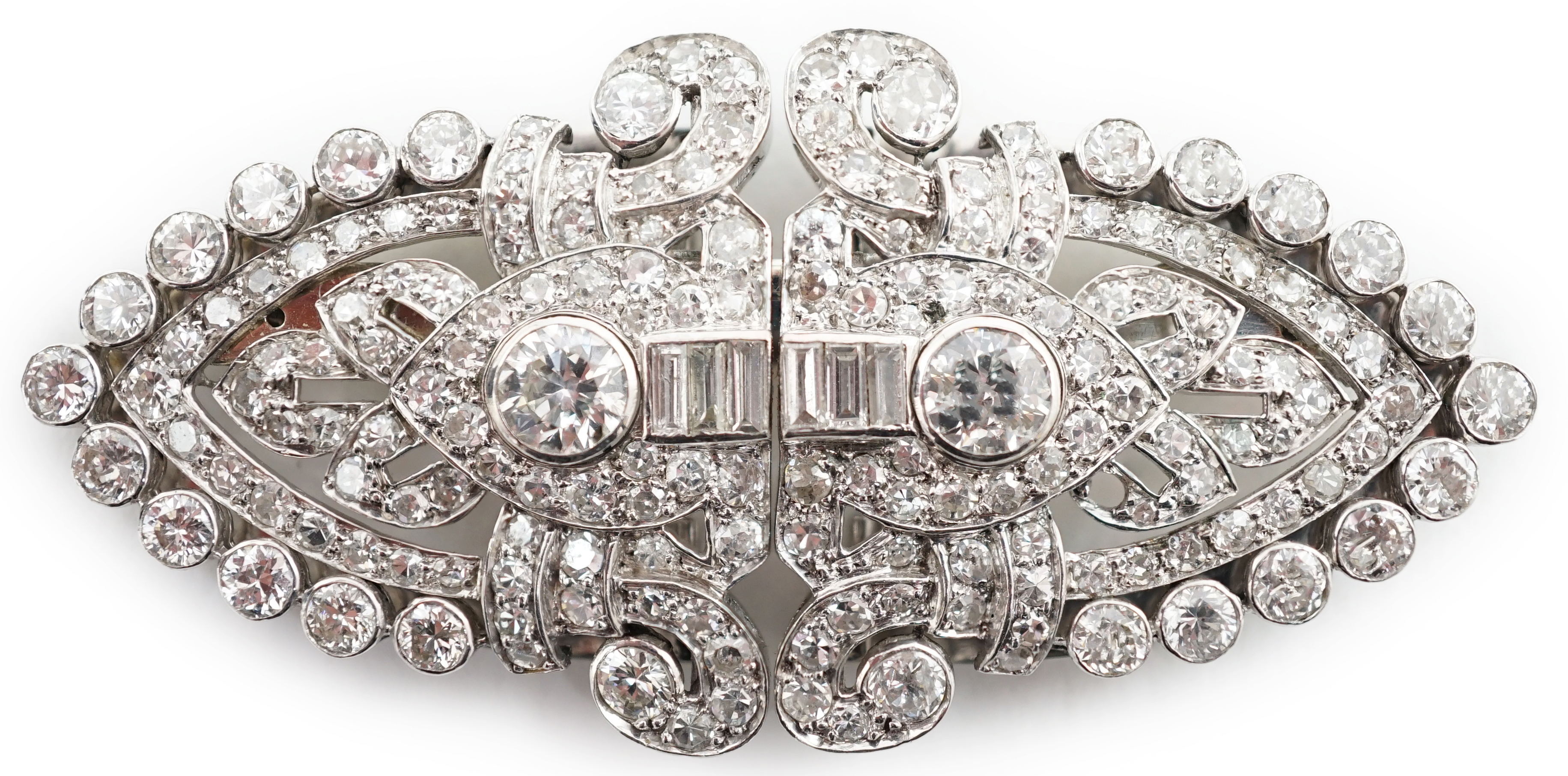 An Art Deco white gold, round and baguette cut diamond set double clip brooch